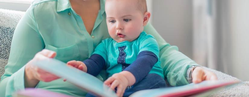 baby reading with mother