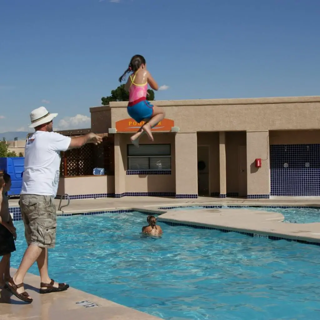 Father-Throwing-Kid-in-Pool-kids-swimming-blog-post