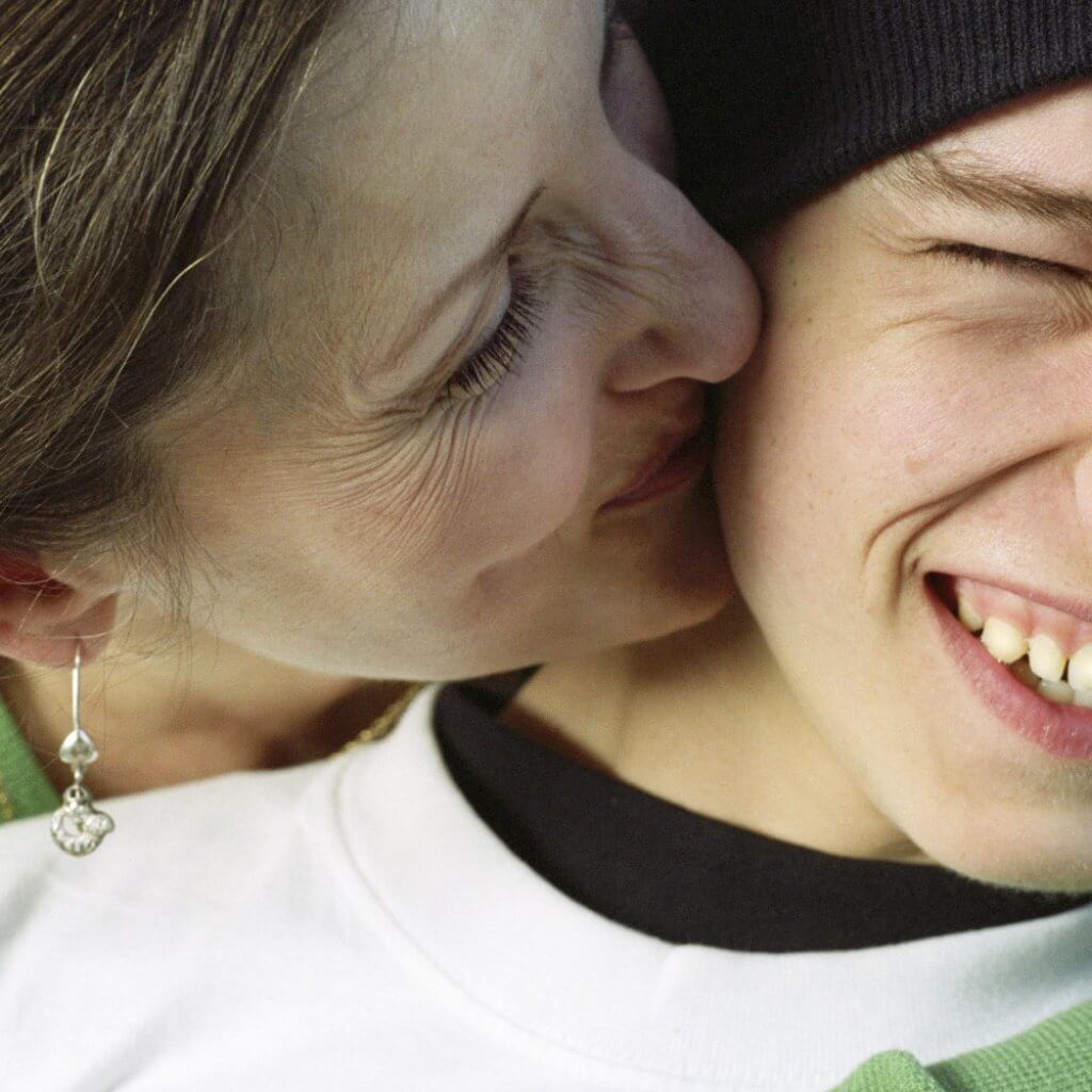 mother-kissing-son-happily