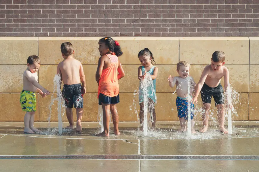 children playing in a fountain